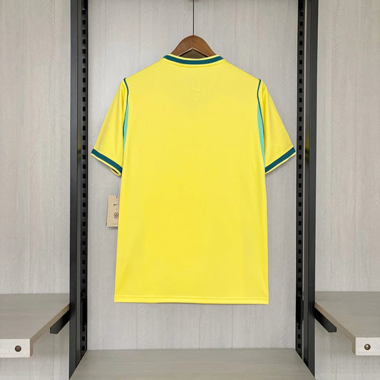 Yellow sports jersey with green accents on a hanger in a locker room.