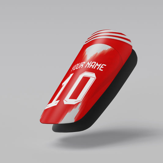 Red and black shin guard with customizable text on a gray background
