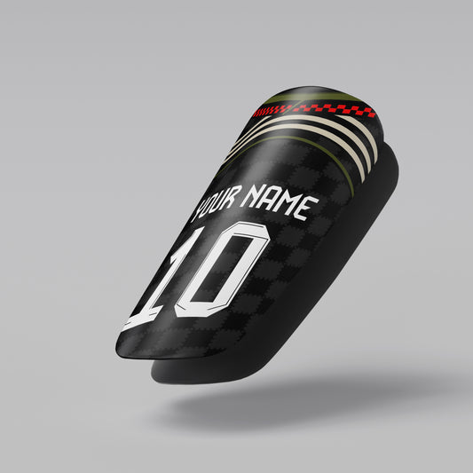 Black shin guard with customizable text on a gray background