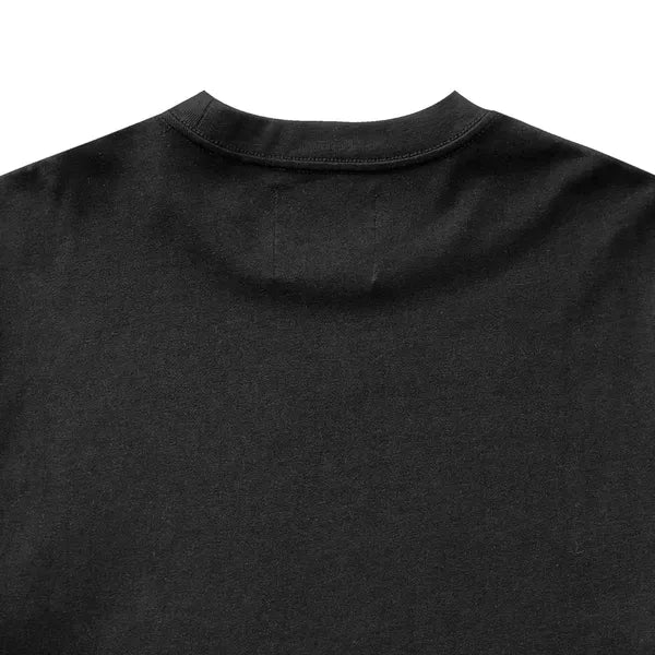 Close-up of a black t-shirt with a collar on a white background