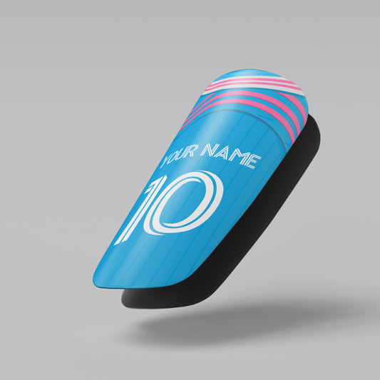 Blue and pink shin guard with customizable text on a gray background