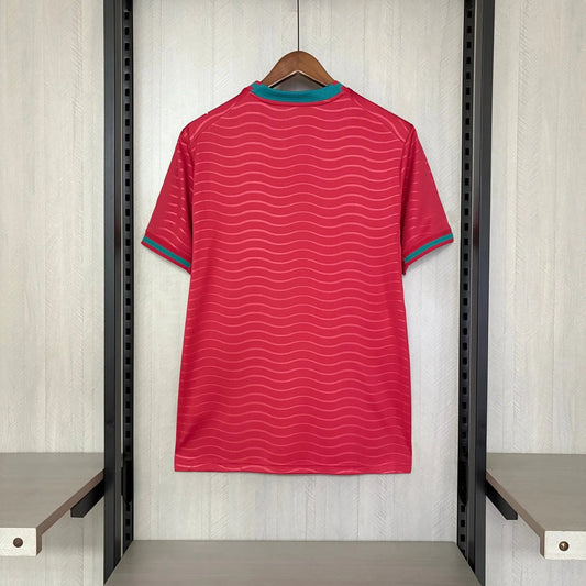 Red striped shirt on a hanger against a neutral background