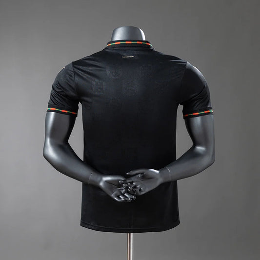 Black polo shirt on a mannequin against a gray background