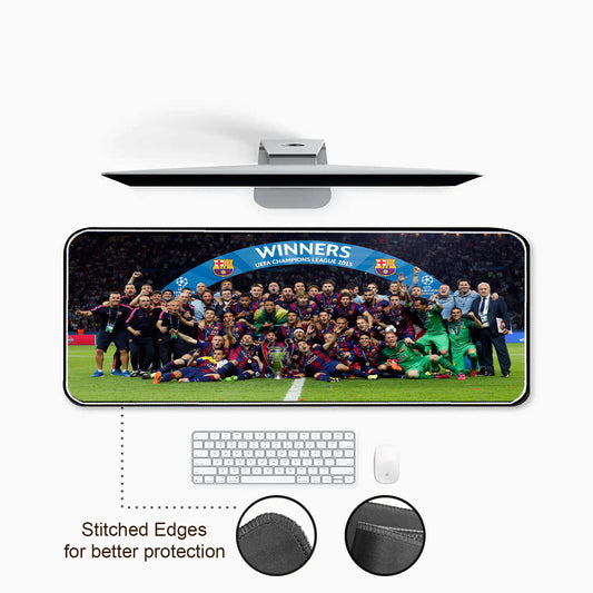 Large mouse pad with sports team image and text, placed on a desk with keyboard and mouse.