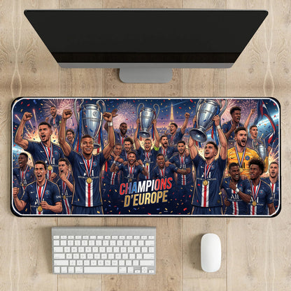 Desk setup with a large mouse pad featuring a sports team celebrating with trophies on a wooden desk.