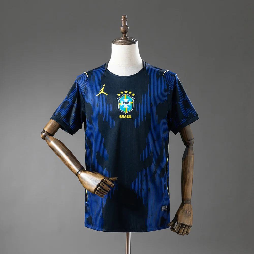 Blue sports jersey with brand logo on a mannequin against a gray background