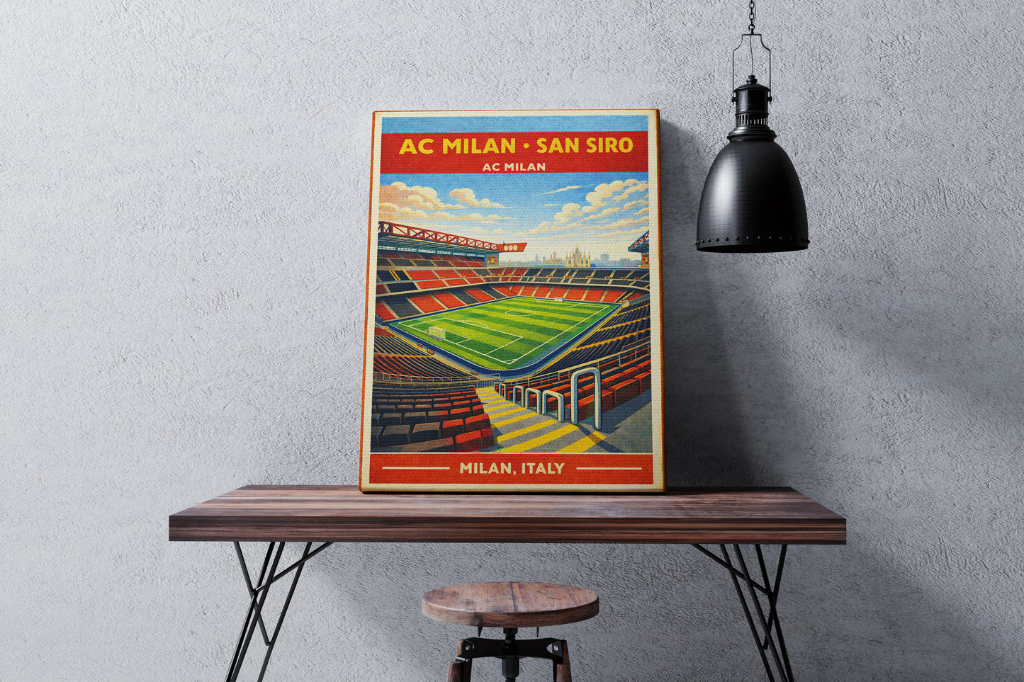 Poster of AC Milan's San Siro stadium on a wooden table against a gray wall.