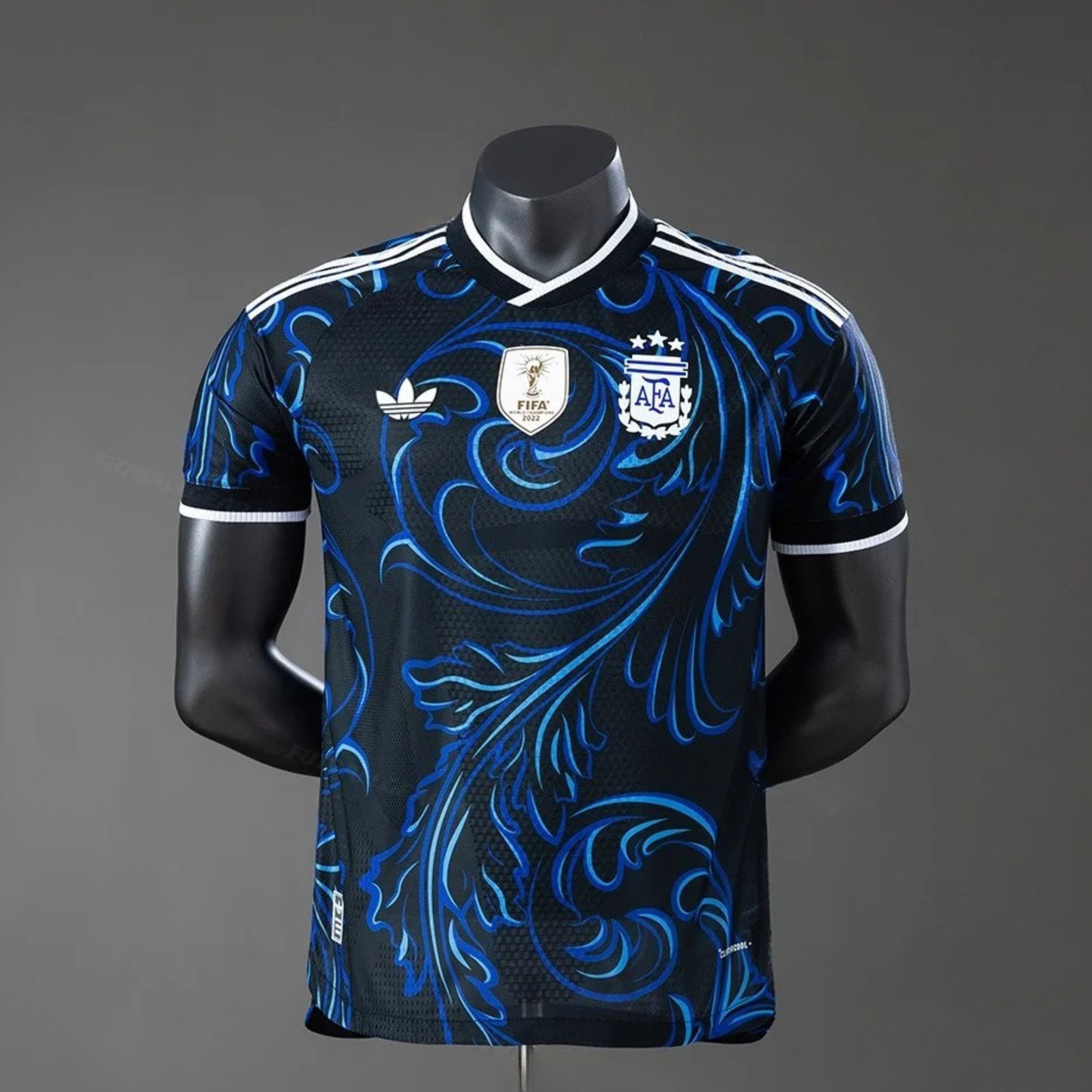 Black and blue patterned sports jersey on a mannequin against a gray background