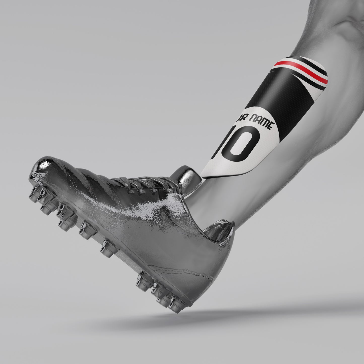 Silver soccer cleat with a black and red armband on a gray background