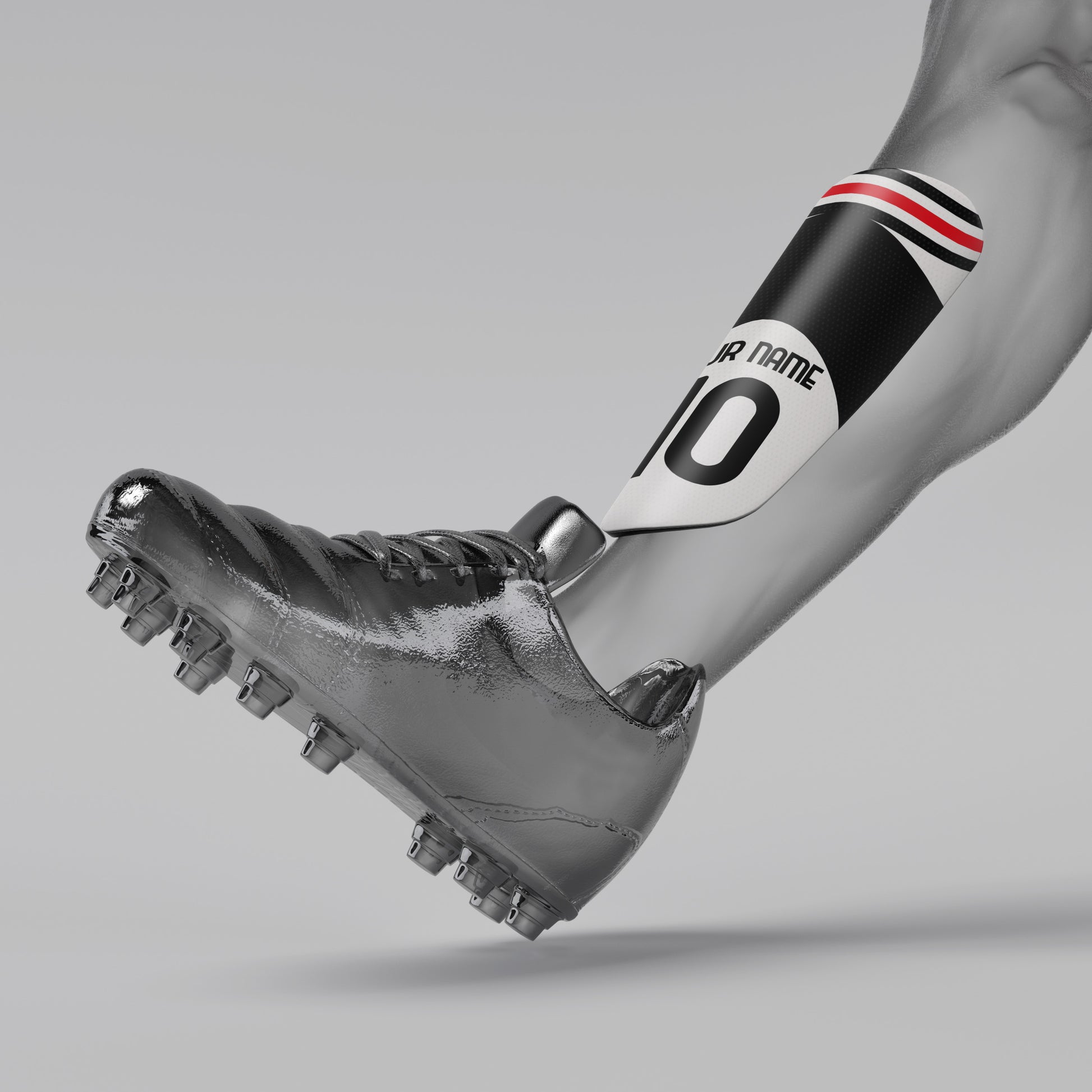 Silver soccer cleat with a black and red armband on a gray background