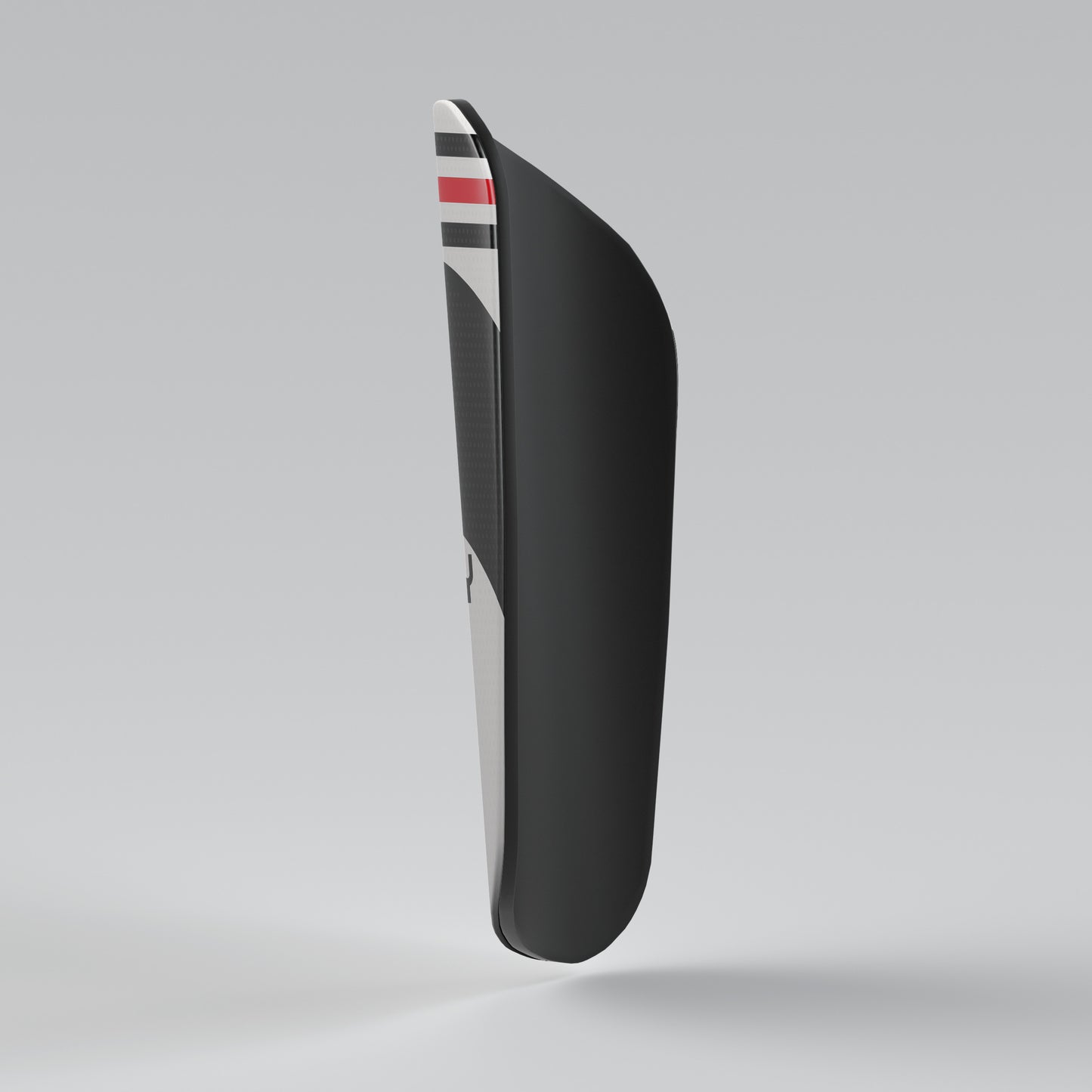 Black shoe sole with a striped pattern on a gray background