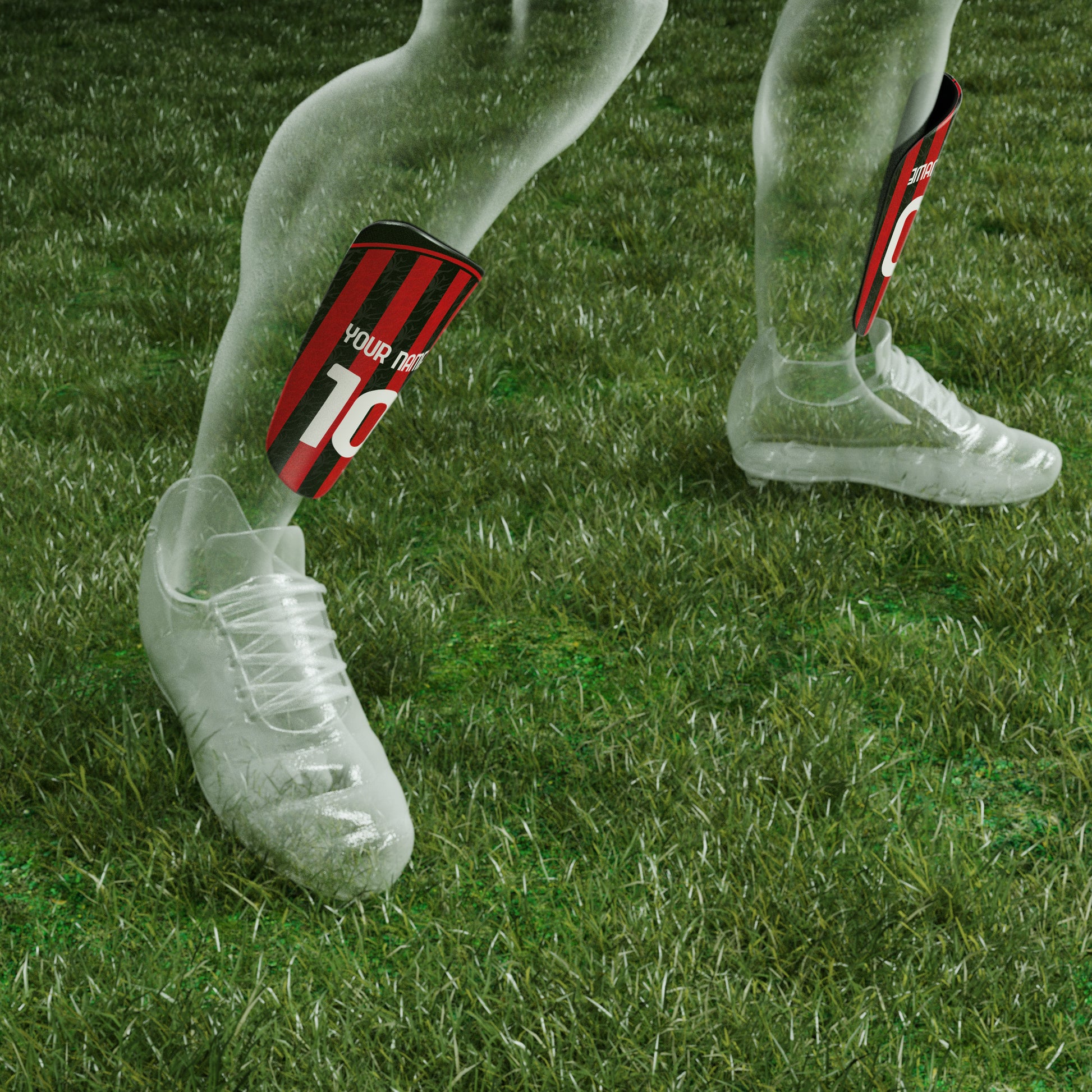 Soccer cleats with red and black striped socks on grass