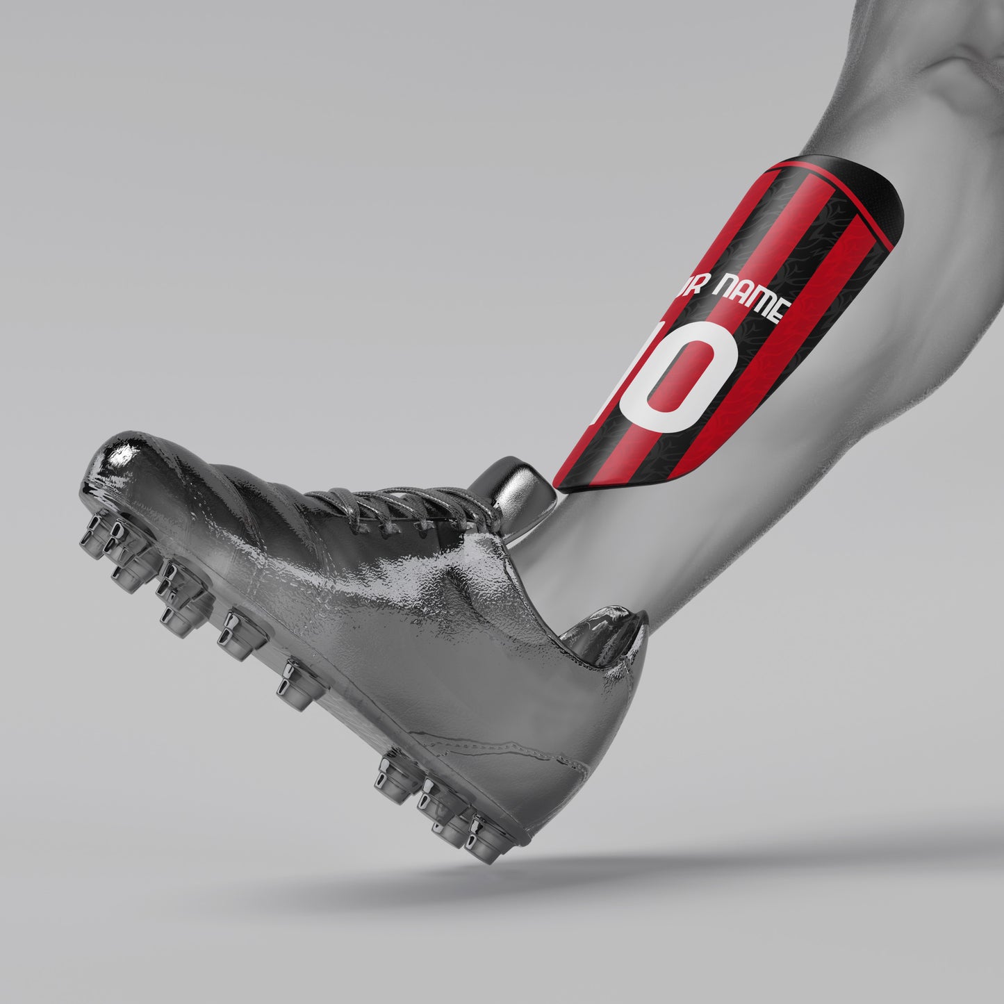 Gray soccer cleat with a red and black shin guard on a gray background