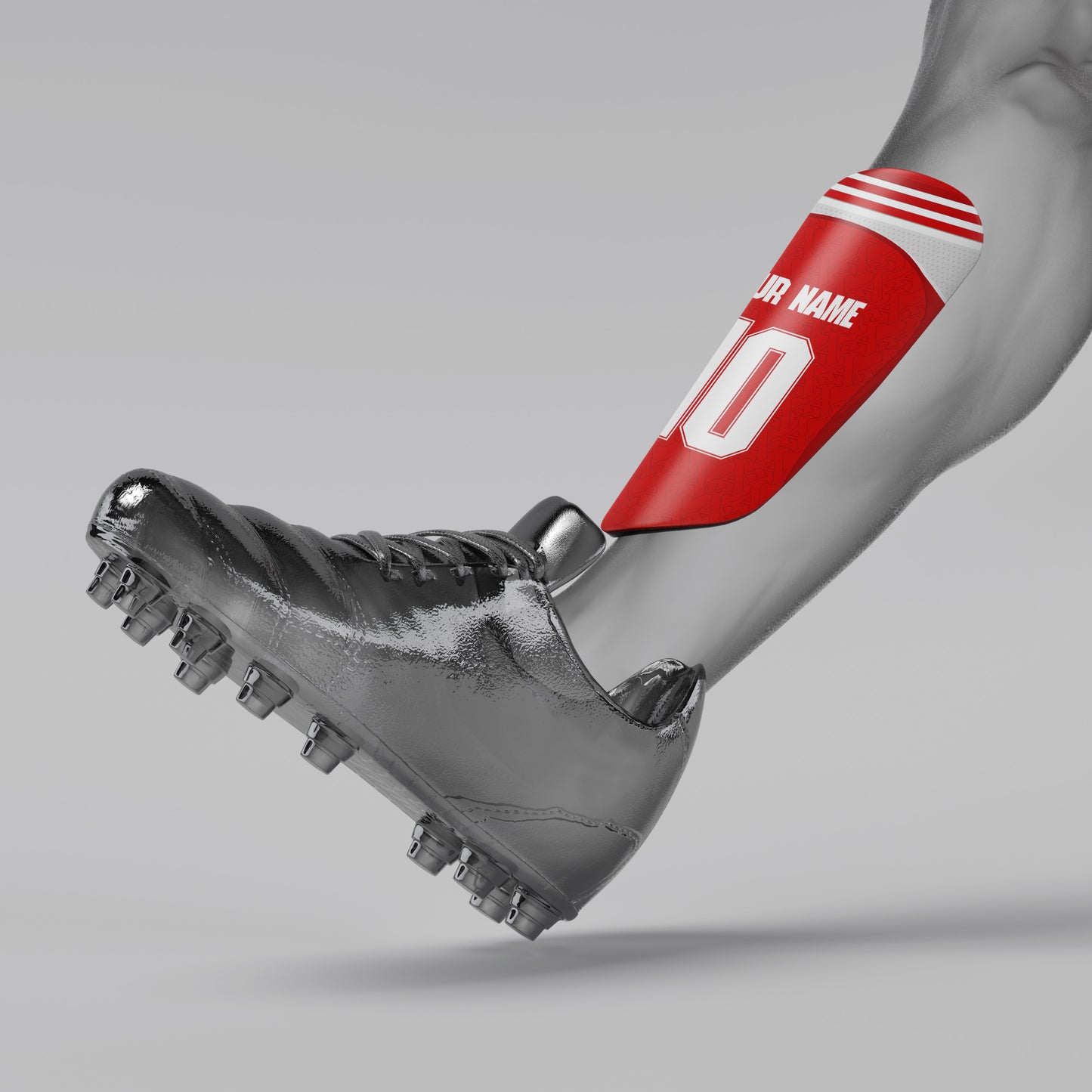 Gray soccer cleat with red shin guard on a gray background