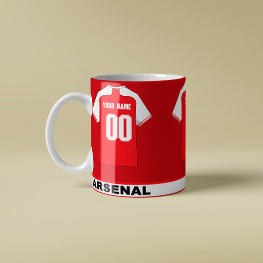 Red mug with Arsenal football club design on a beige background