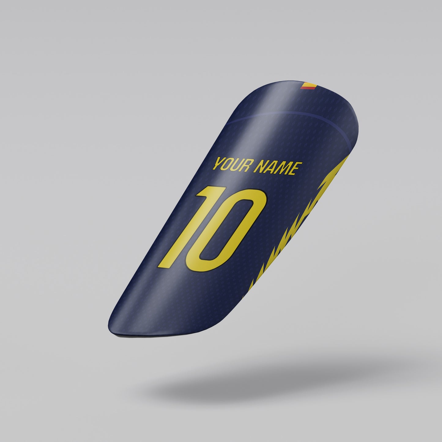 Blue shin guard with yellow text on a gray background