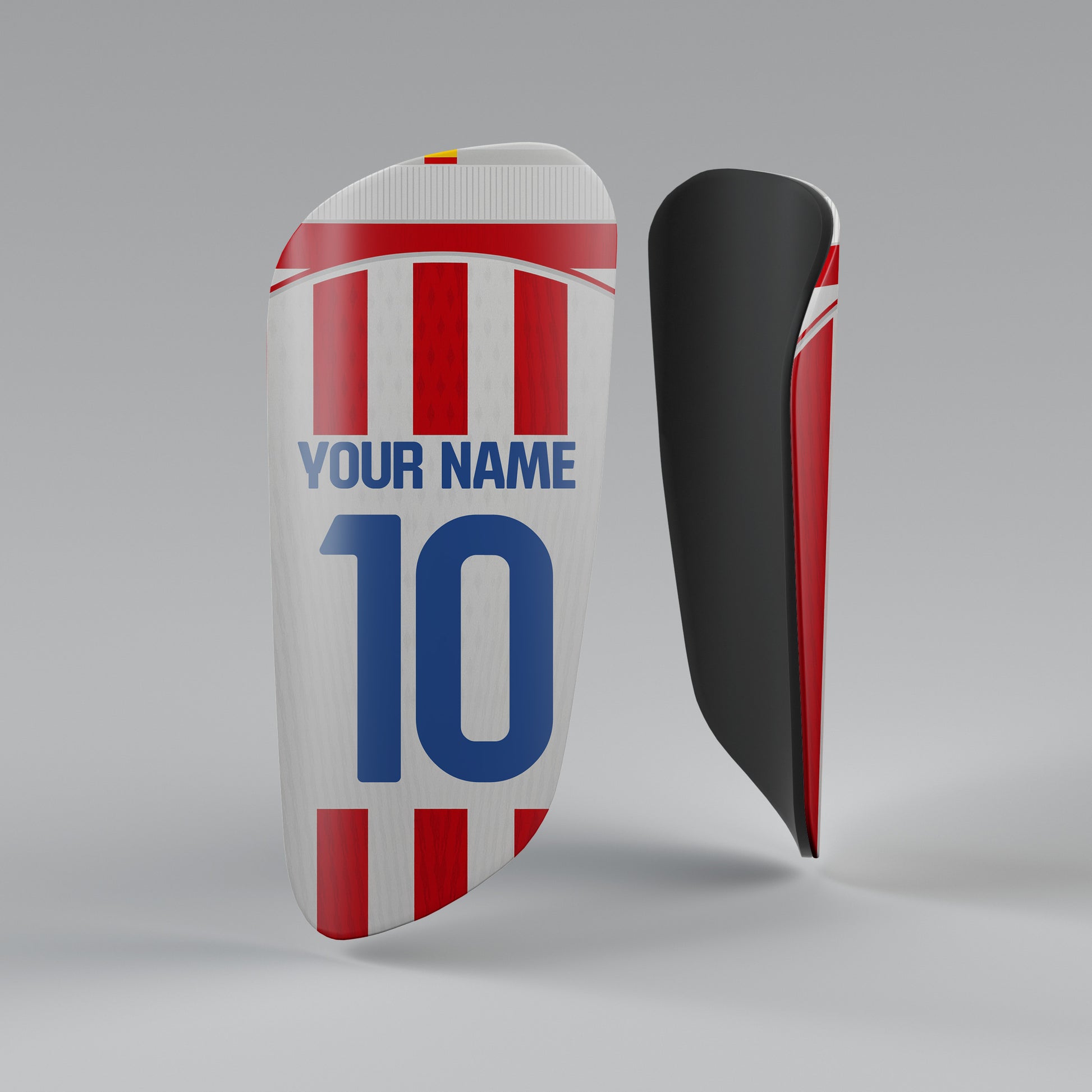 Soccer shin guards with red, white, and blue design on a gray background