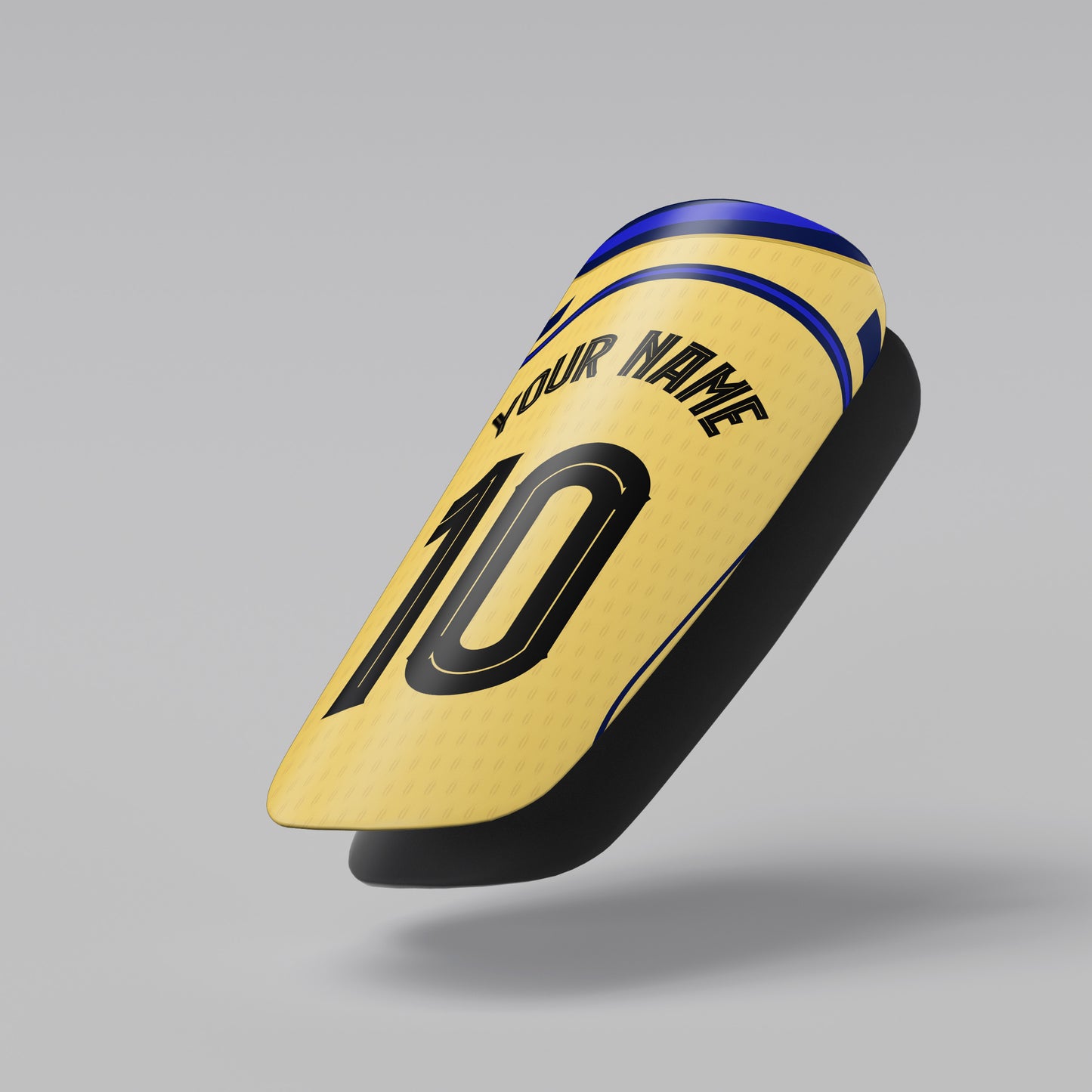 Yellow shin guard with customizable text on a gray background