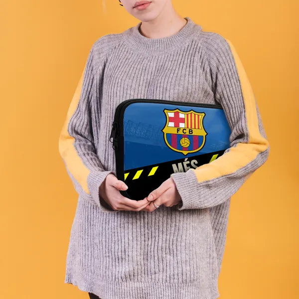 Person holding a pouch with FC Barcelona logo against a yellow background