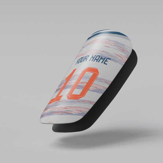 Soccer shin guard with customizable text on a gray background
