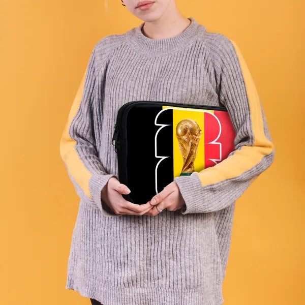 Person holding a small bag with a World Cup trophy design against a yellow background