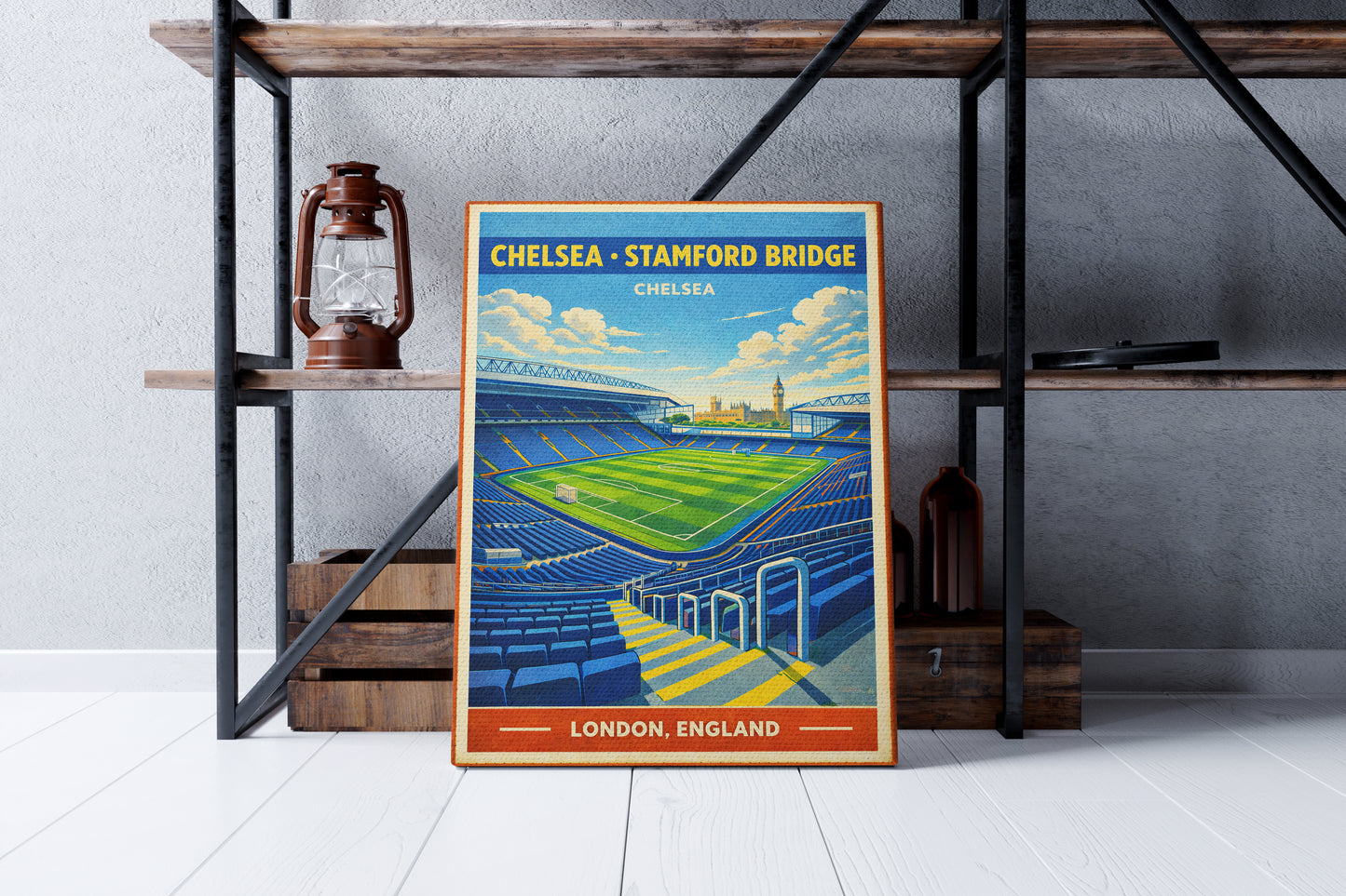 Framed poster of Chelsea Stadium on a shelf against a gray wall.
