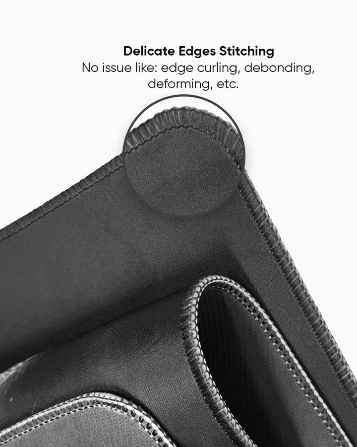 Close-up of a black fabric with stitching details on a white background