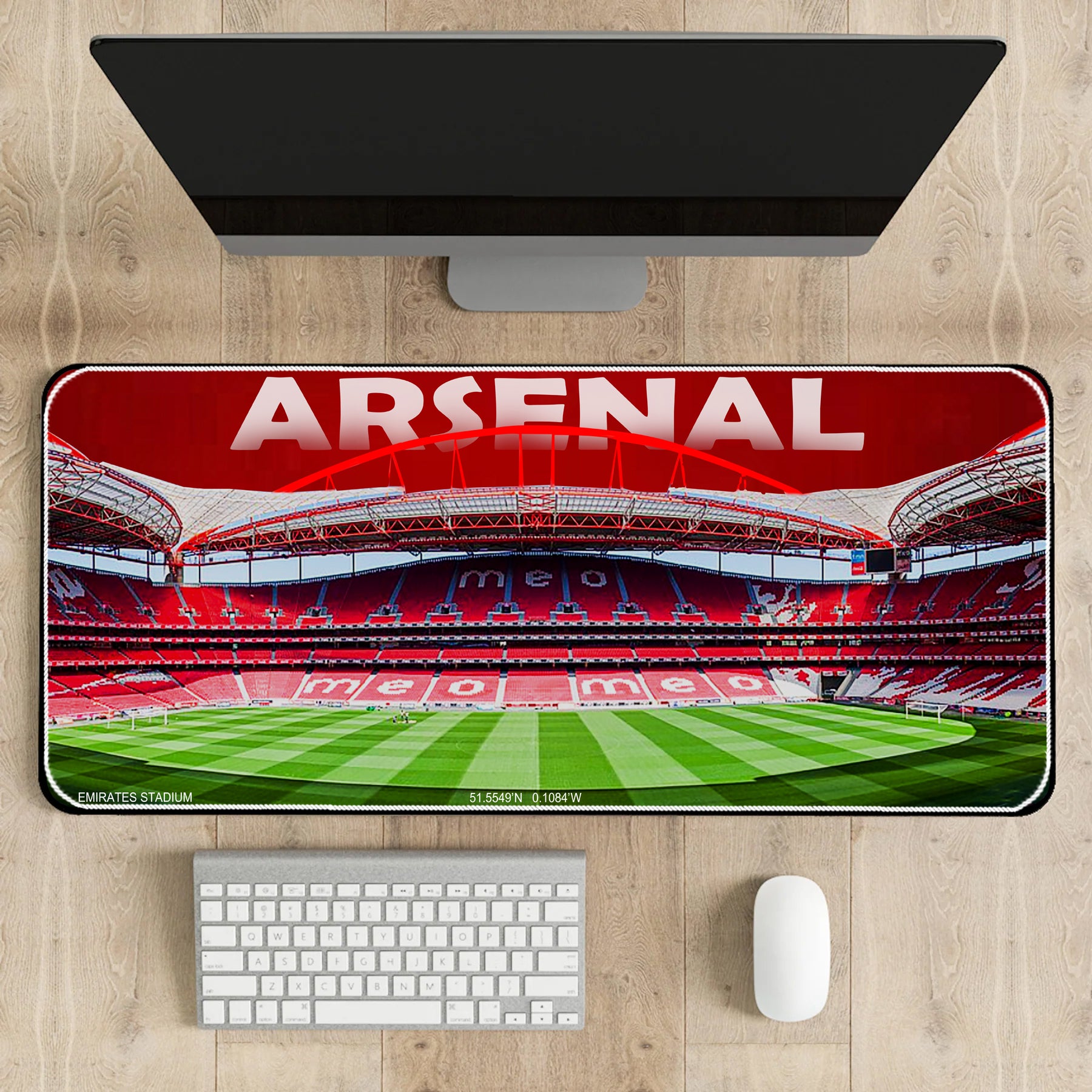 Arsenal stadium mouse pad on a desk with a computer setup
