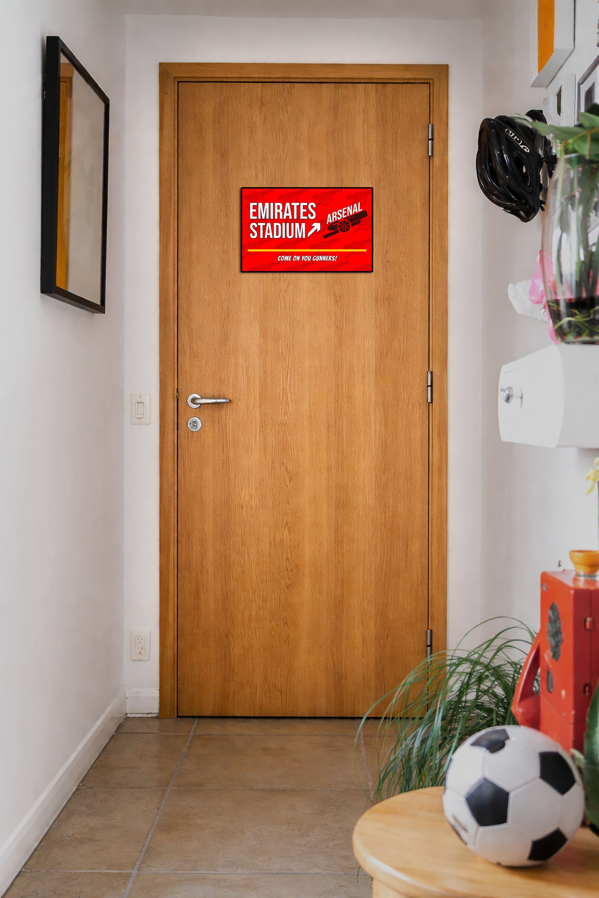 Wooden door with a red sign labeled 'San Siro Stadium' in a hallway.