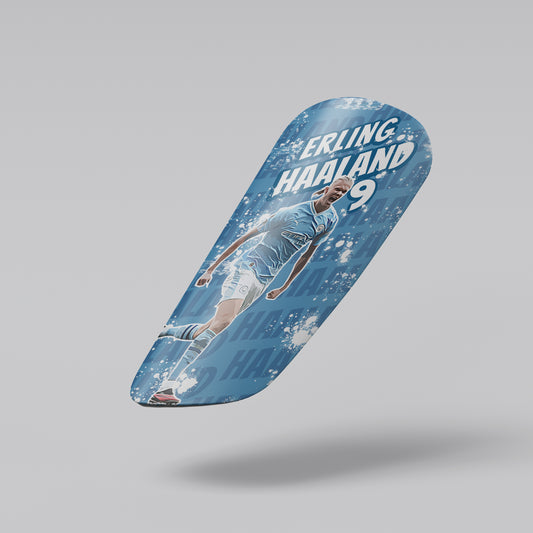 Skateboard deck with a soccer player design and 'Erling Haaland 9' text on a gray background