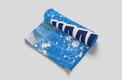 Blue towel with white splashes and logo on a light gray background