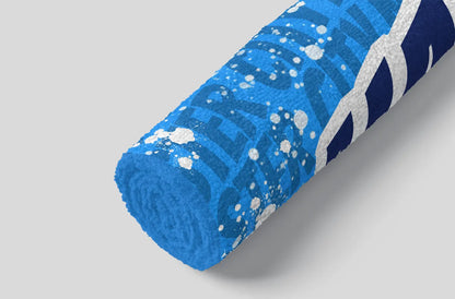 Blue towel with white splashes on a gray background