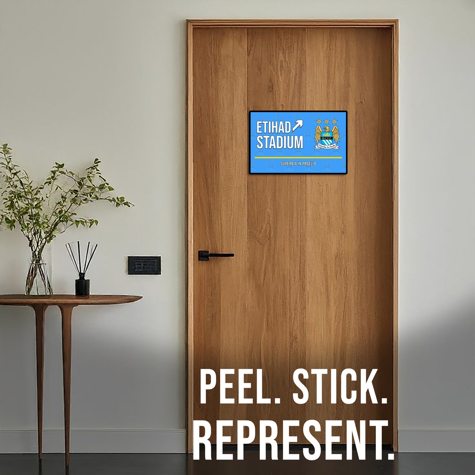 Wooden door with a decorative sign and 'Peel. Stick. Represent.' text.