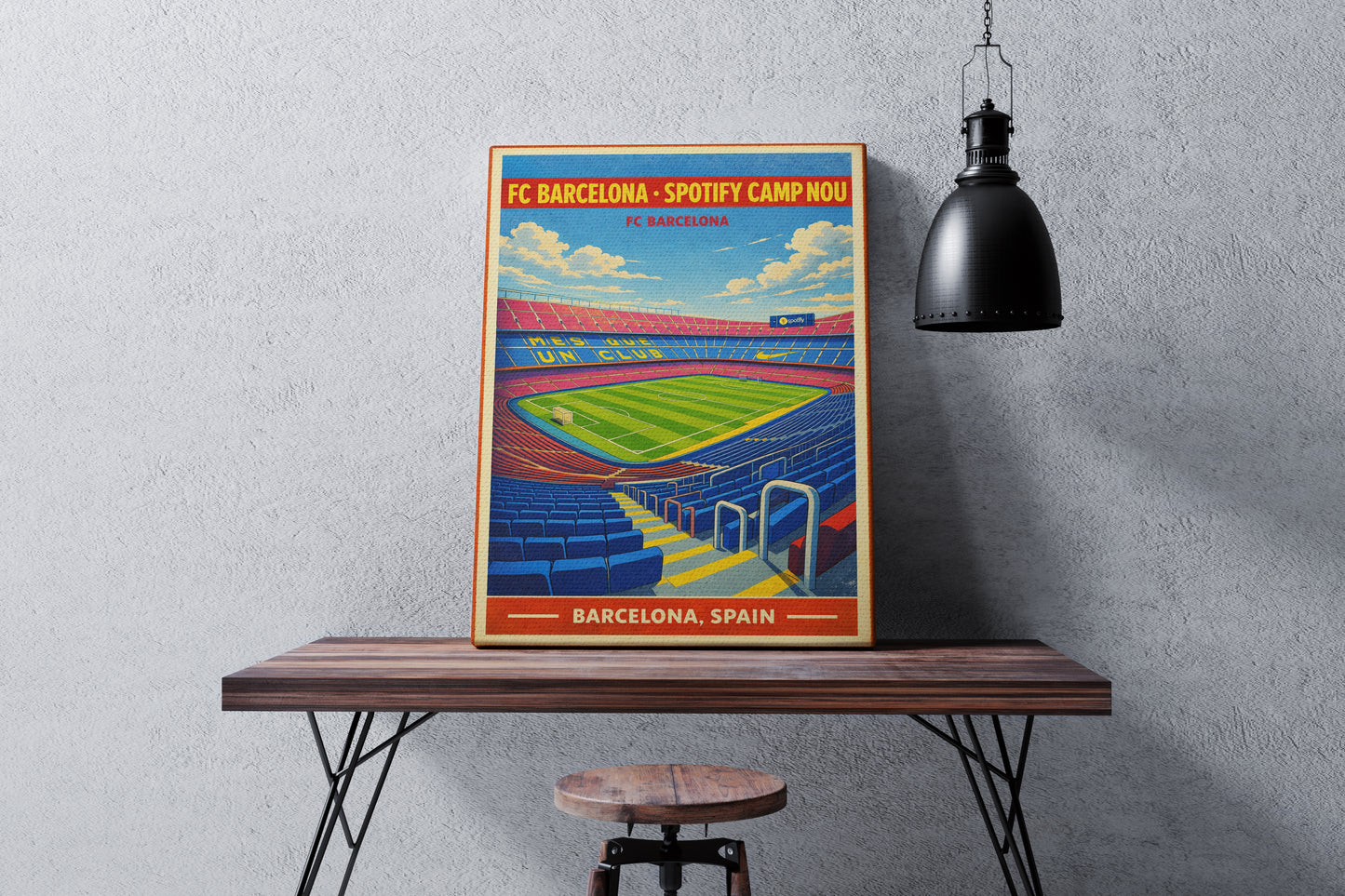 Poster of FC Barcelona's Camp Nou stadium on a wooden table against a gray wall.