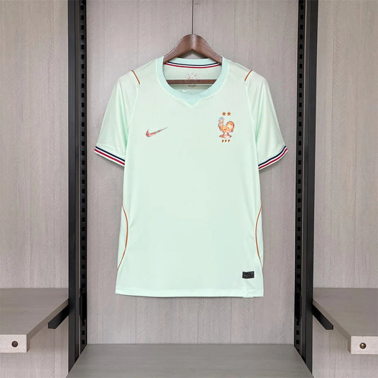 Light green sports jersey with Nike logo on a hanger against a wooden background
