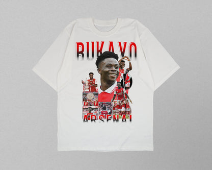 White t-shirt with a collage of images and text on a gray background