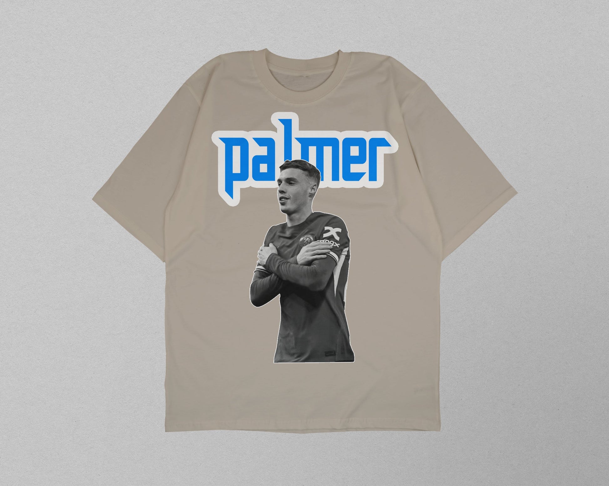 Beige t-shirt with a graphic of a person and 'palmer' text on a gray background
