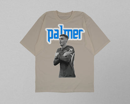 Beige t-shirt with a graphic of a person and 'palmer' text on a gray background