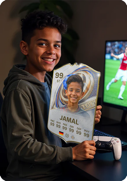 Child holding a 'Jamal' card with a soccer theme, smiling in front of a screen showing a soccer game.