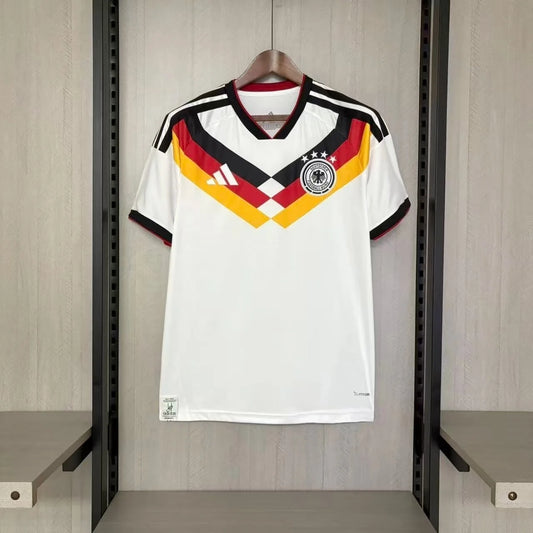 White sports jersey with red, yellow, and black design hanging on a rack.