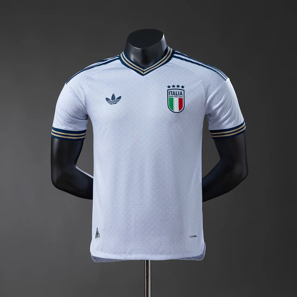 White sports jersey with Italian flag emblem on a mannequin against a dark background