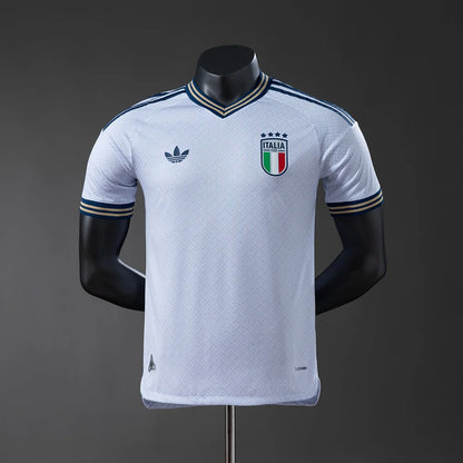 White sports jersey with Italian flag emblem on a mannequin against a dark background