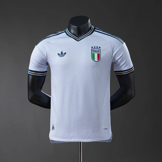 White sports jersey with Italian flag emblem on a mannequin against a dark background