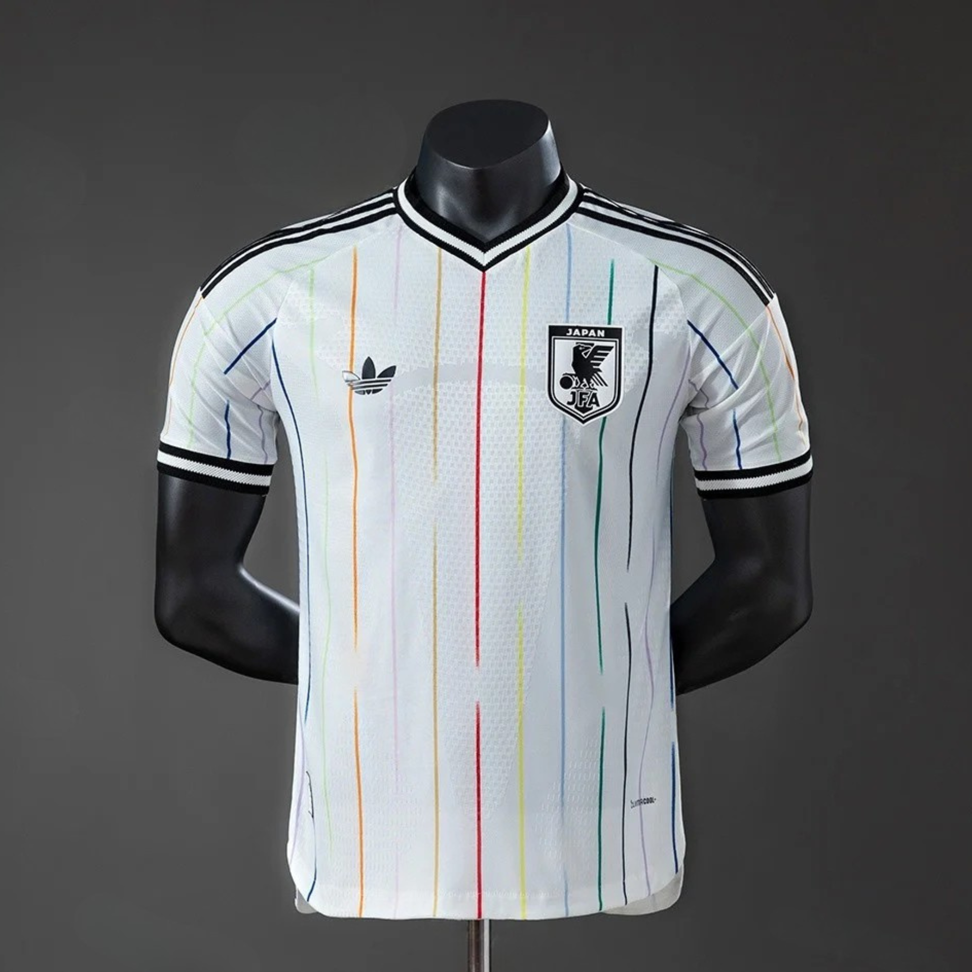 White sports jersey with colorful stripes on a mannequin against a dark background