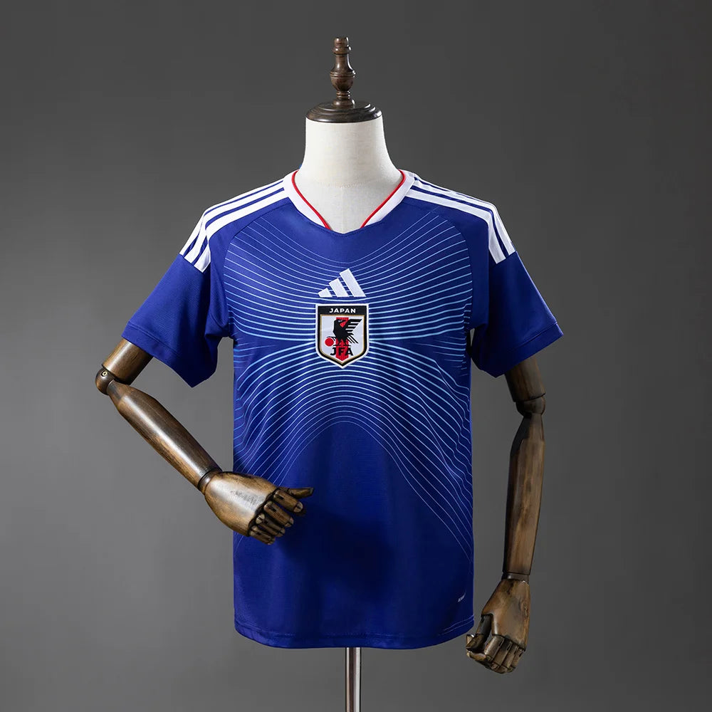 Blue sports jersey with Adidas logo on a mannequin against a gray background