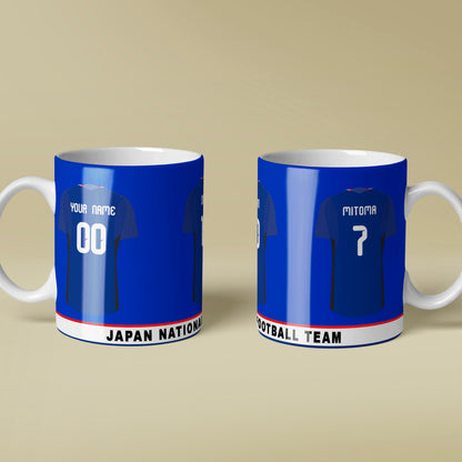 Two blue and white mugs with soccer jersey designs on a beige background