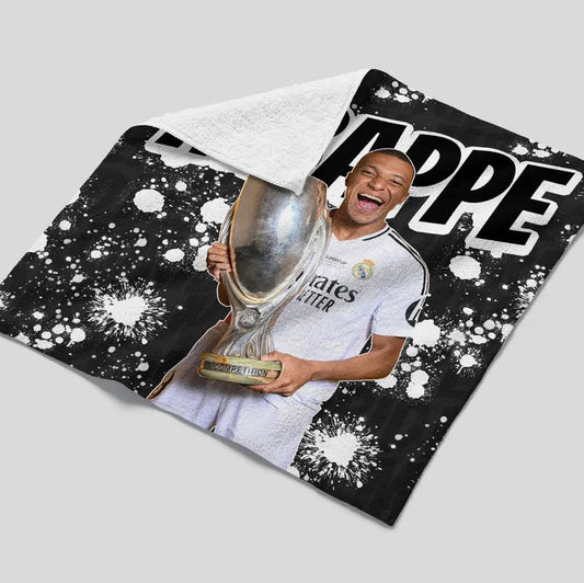 Person holding a trophy on a black and white patterned background