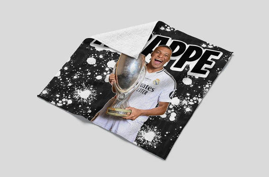 Person holding a trophy on a black and white patterned background