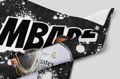 Pillow with soccer-themed design featuring a shoe and text on a black and white background