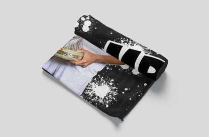 Black and white patterned pouch with a hand holding money on a light gray background
